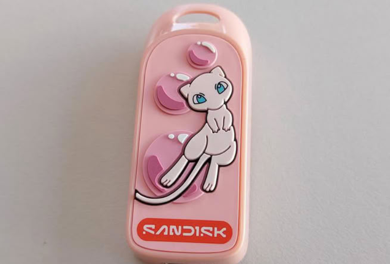 Homepage 2026 16 Sandisk Pokémon Portable SSD in Mewtwo edition next to the Mew-themed USB-C flash drive