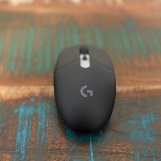 Black Logitech mouse, top view angle