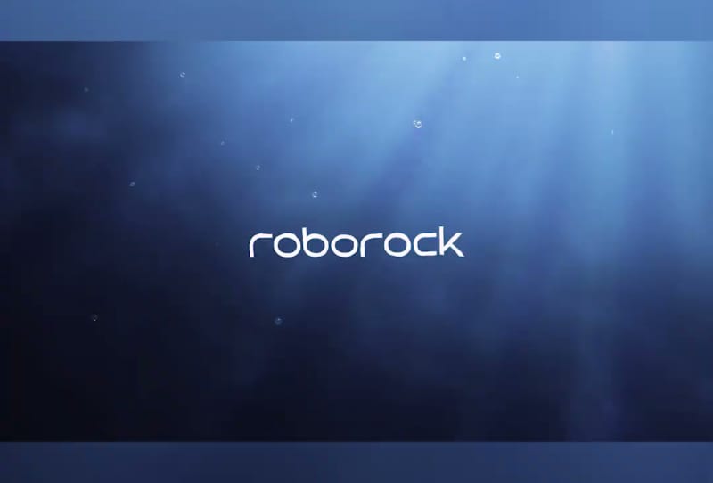 Roborock RockAqua P1 robotic pool cleaner floating at the waterline of a swimming pool