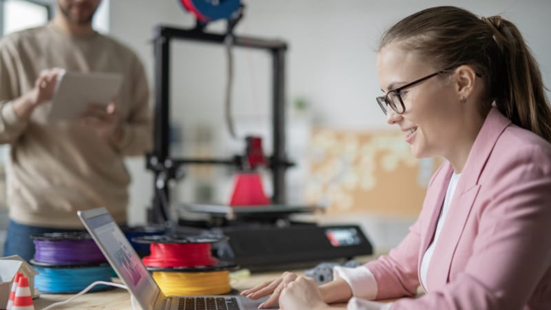 A 3D printer running on a desk in a home office, illustrating 3D printer bedroom safety concerns around ventilation