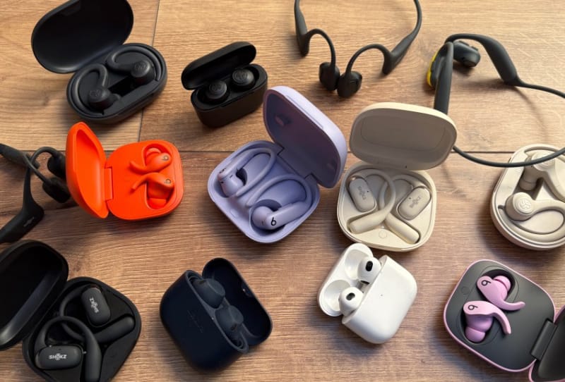 A runner wearing wireless earbuds with an earhook design while jogging outdoors