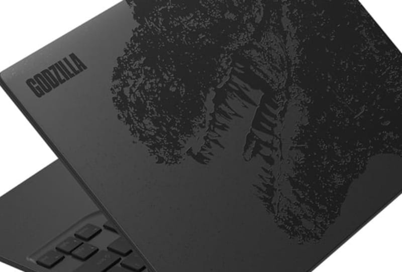 Fujitsu Godzilla laptop lid showing a black Godzilla illustration and dorsal fin shaped touchpad