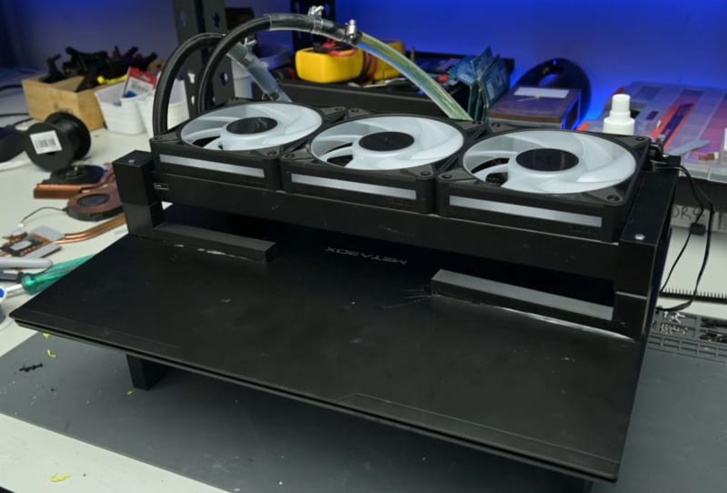 Homepage 2026 1 Laptop AIO radiator mod showing external tubing and fans attached to a gaming laptop chassis